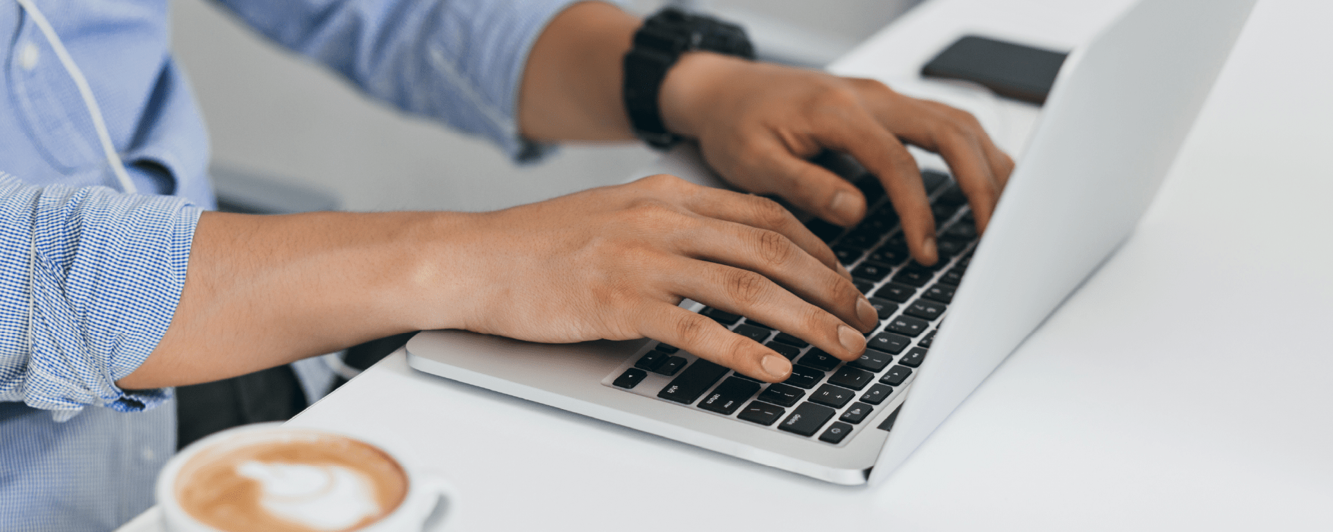 ATRIUM Software by CDVI | Man using a laptop zoomed in on his hands on the keyboard