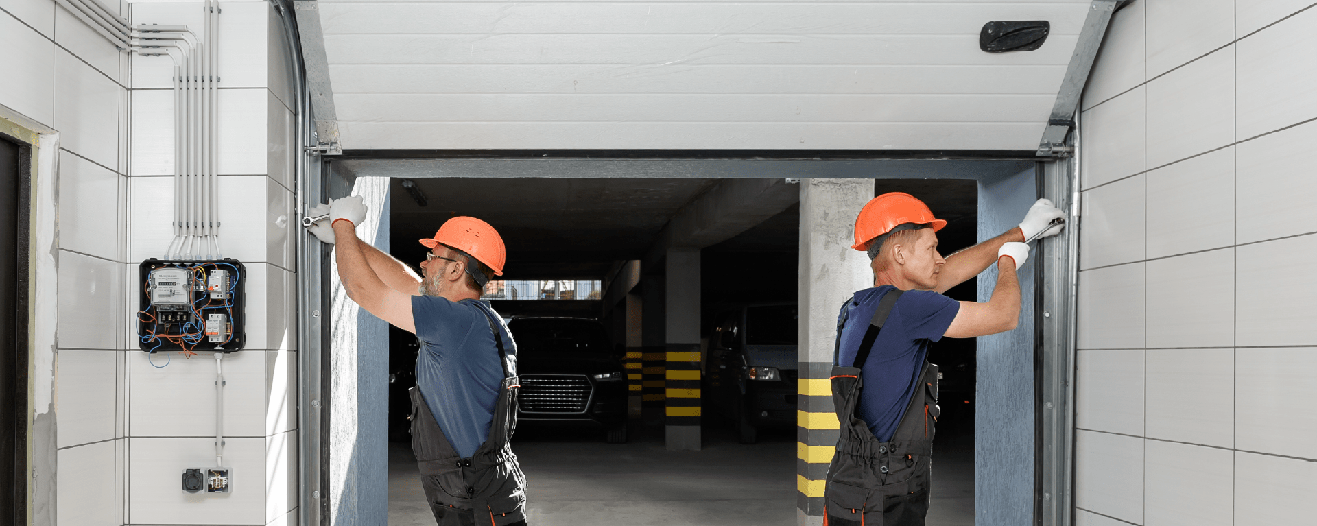 Installers working on double doors in overalls and hard hats